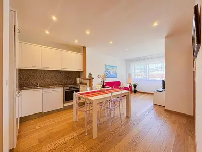 a kitchen and dining room with a table and chairs at Suite Zara - wifi, AC, 4 pers in Nice
