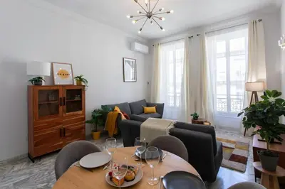 a living room with a couch and a table at #57 Suite Notre Dame Central balcony & AC in Nice