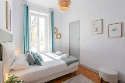 a bedroom with a bed with a window at #57 Suite Notre Dame Central balcony & AC in Nice