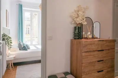 a bedroom with a dresser and a bed with a window at #57 Suite Notre Dame Central balcony & AC in Nice