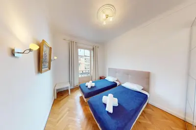 a bedroom with two beds with crosses on them at Bright air-conditioned flat in the city centre in Nice
