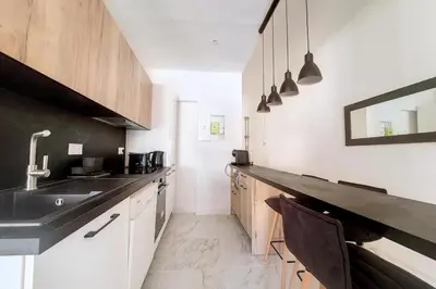 a kitchen with a sink and a counter top at Bright air-conditioned flat in the city centre in Nice