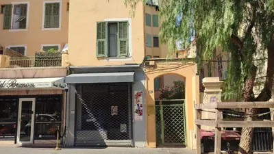 a store on a street with a building at Appartement port et vieux Nice Direct from Airport by tramway in Nice