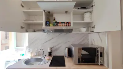 a kitchen counter with a microwave and a sink at Appartement port et vieux Nice Direct from Airport by tramway in Nice