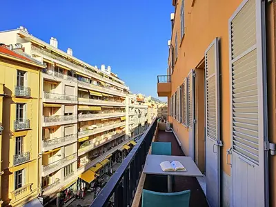a balcony with a table and chairs on a building at Nestor&Jeeves - COTE PIETONNE - Central - By sea - Pedestrian zone in Nice
