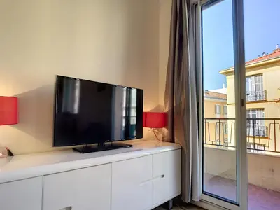 a flat screen tv sitting on top of a white cabinet at Nestor&Jeeves - COTE PIETONNE - Central - By sea - Pedestrian zone in Nice