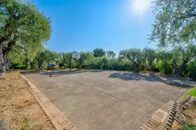 an empty parking lot in a park with trees at Superbe 2 pièces Clim et Parking in Nice
