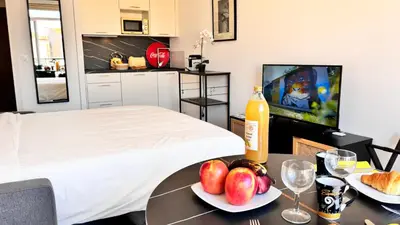 a room with a bed and a table with fruit on it at Ze Perfect Place - Studio centre-ville - Masséna in Nice