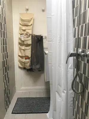 a shower with a white shower curtain in a bathroom at Chambre Nice hyper centre ville in Nice