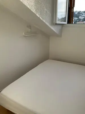 a white bed in a room with a window at Chambre Nice hyper centre ville in Nice