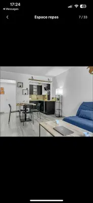 a living room with a bed and a table at Le Rieviera Bay-Parking-Jardin Pick up Airport in Saint-Laurent-du-Var