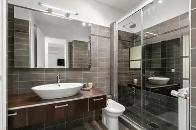 a bathroom with a sink and a toilet and a mirror at Suite Prestige FSHH in Nice