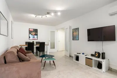 a living room with a couch and a flat screen tv at Suite Prestige FSHH in Nice