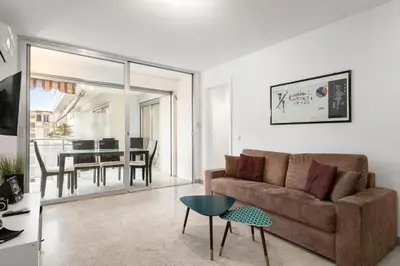 a living room with a couch and a table at Suite Prestige FSHH in Nice