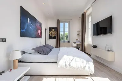 a kitchen with white counters and a stainless steel refrigerator at Le Massena in Nice