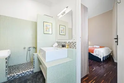 a bathroom with a sink and a bed at Sunlight Properties - Capitaine 54 - 1 Bedroom, stunning holiday rental apartment with balcony and port view in Nice