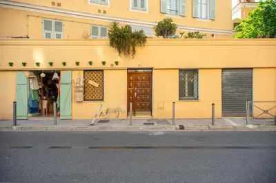a yellow building on the side of a street at Sunlight Properties - Capitaine 54 - 1 Bedroom, stunning holiday rental apartment with balcony and port view in Nice