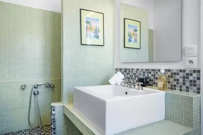 a bathroom with a white sink and a shower at Sunlight Properties - Capitaine 54 - 1 Bedroom, stunning holiday rental apartment with balcony and port view in Nice