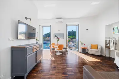a kitchen and living room with a table and chairs at Sunlight Properties - Capitaine 54 - 1 Bedroom, stunning holiday rental apartment with balcony and port view in Nice