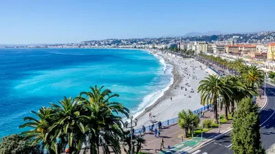 a beach in tropea with palm trees and the ocean at Studio Emmé neuf indépendant Nice Centre in Nice
