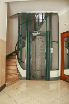 a large door in a building with a staircase at Cosy 3 pièces à 5 min de la PROM in Nice