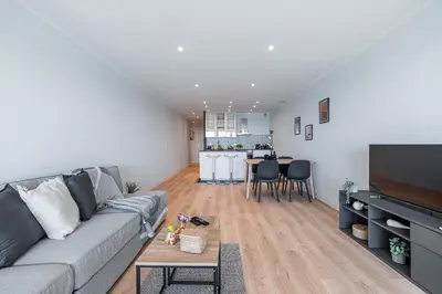 a living room with a gray couch and a table at Panoramic Sea View - 1 Bdr Promenade des Anglais in Nice
