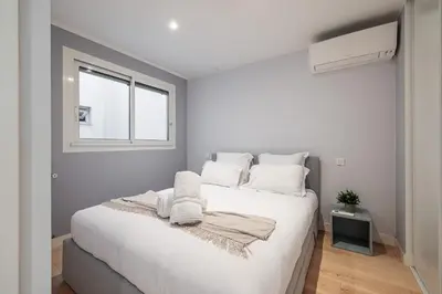 a bedroom with a large white bed with a window at Panoramic Sea View - 1 Bdr Promenade des Anglais in Nice