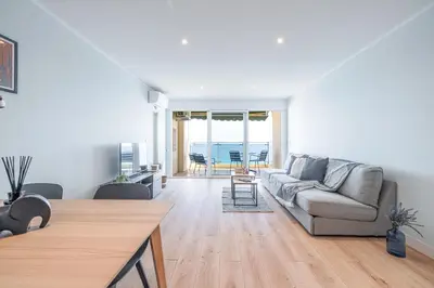 a living room with a couch and a table at Panoramic Sea View - 1 Bdr Promenade des Anglais in Nice