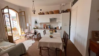 a kitchen and dining room with a table and chairs at Arty room in Nice