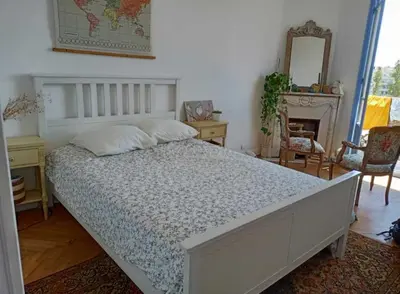 a bedroom with a large bed and a mirror at Arty room in Nice