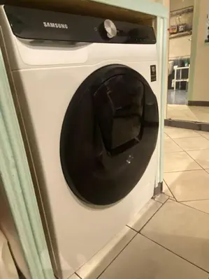 a white washing machine with a black door at Grand Studio très bien situé! in Nice