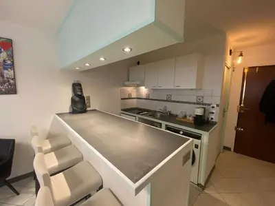 a kitchen with a counter and a stove top oven at Grand Studio très bien situé! in Nice