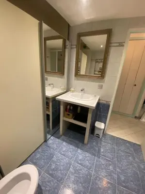 a bathroom with a toilet and a sink and mirror at Grand Studio très bien situé! in Nice