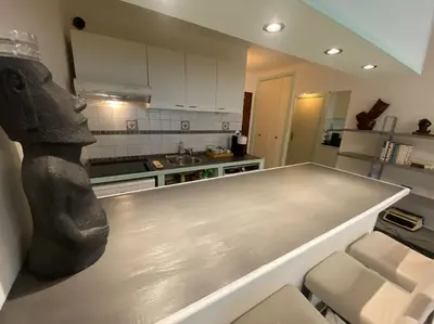 a kitchen with a counter top in the middle at Grand Studio très bien situé! in Nice