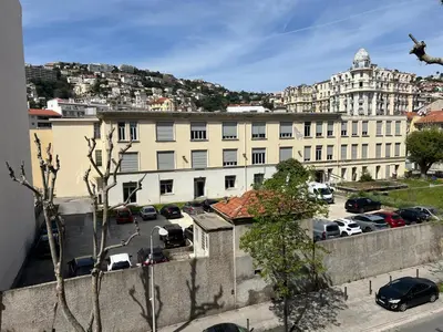 a large white building with cars parked in a parking lot at Appartement Nice 2 chambre 2 lits 1 salle de bain in Nice
