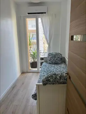 a small bedroom with a bed and a window at Appartement Nice 2 chambre 2 lits 1 salle de bain in Nice