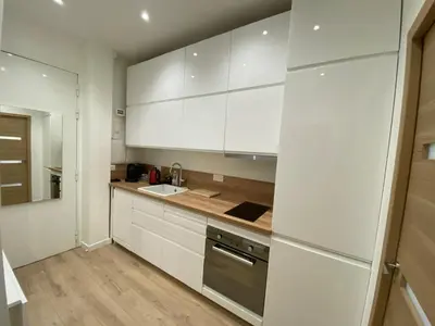 a kitchen with white cabinets and a sink at Appartement Nice 2 chambre 2 lits 1 salle de bain in Nice