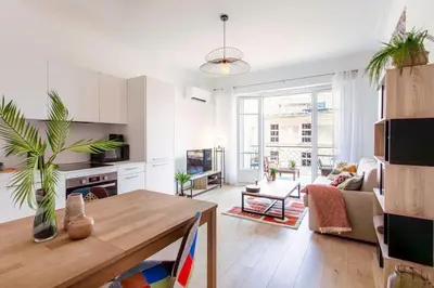a white living room with a table and a living room at L53 1BR Hotel des Postes, Place Massena Terrace & AC in Nice