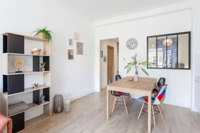 a dining room with a wooden table and chairs at L53 1BR Hotel des Postes, Place Massena Terrace & AC in Nice
