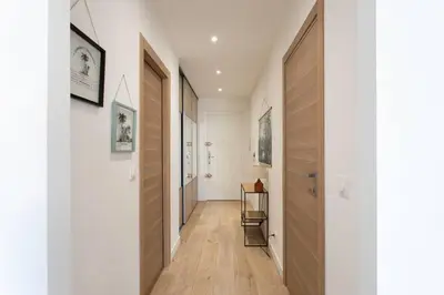 a hallway with white walls and wooden floors at L53 1BR Hotel des Postes, Place Massena Terrace & AC in Nice