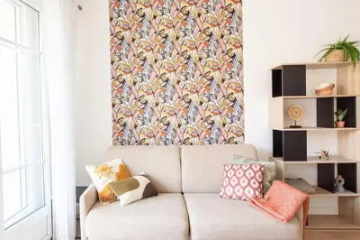 a living room with a couch and a floral wall at L53 1BR Hotel des Postes, Place Massena Terrace & AC in Nice
