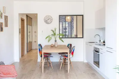 a kitchen and dining room with a table and chairs at L53 1BR Hotel des Postes, Place Massena Terrace & AC in Nice