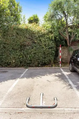 a skateboard in a parking lot next to a car at Le Mimosa - Calm - Spacious - 200m from the sea - Parking in Cagnes-sur-Mer