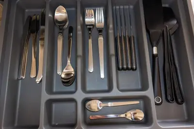 a plastic container filled with utensils and forks and spoons at Le Mimosa - Calm - Spacious - 200m from the sea - Parking in Cagnes-sur-Mer