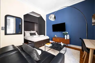 a living room with a couch and a bed at Raffinement en pleine ville in Nice