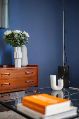 a glass table with a vase of flowers and a dresser at Raffinement en pleine ville in Nice