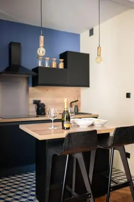 a kitchen with a table with a bottle of wine at Raffinement en pleine ville in Nice