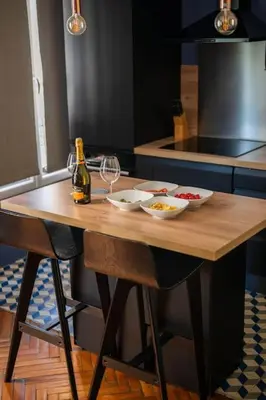 a table with two glasses and a bottle of wine at Raffinement en pleine ville in Nice