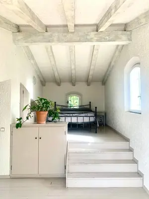 a bedroom with a bed in a room with stairs at THE GREEN OASIS breathtaking sea views, swimming pool, privacy in Villa Liliana in Tourrette-Levens