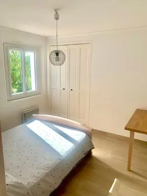 a bedroom with a bed in a room with a window at THE GREEN OASIS breathtaking sea views, swimming pool, privacy in Villa Liliana in Tourrette-Levens